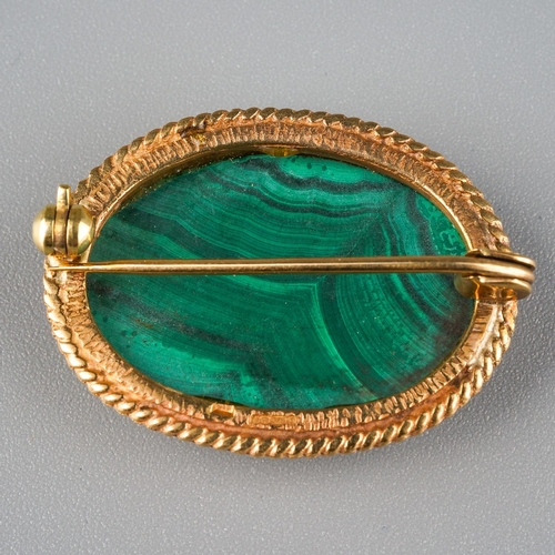 737 - A 9ct gold malachite brooch. Set with an oval malachite cabochon, within a rope twist border, hallma... 