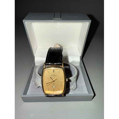 750 - A 9ct gold Roamer wristwatch. The champaign coloured dial, black enamel gilt hourly applied markers,... 