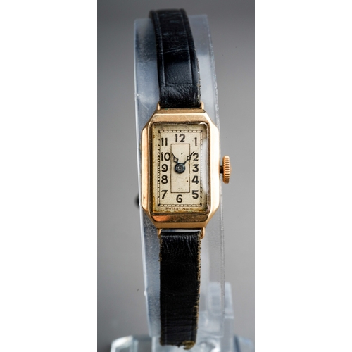 751 - A ladies 1930s 9ct gold wristwatch. The cream coloured dial with black Arabic numerals, blue steel h... 