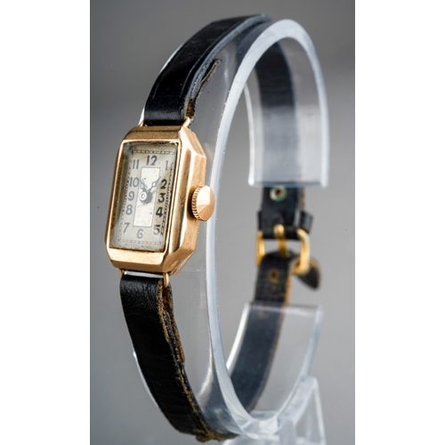 751 - A ladies 1930s 9ct gold wristwatch. The cream coloured dial with black Arabic numerals, blue steel h... 