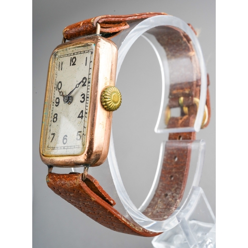 753 - A 1920s 9ct gold wristwatch. The rectangular silver dial with black Arabic numerals, blue steel hand... 