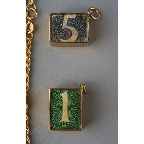 762 - Two 9 ct gold money blocks, 9 ct gold chain, 9 ct gold religious pendant on chain. Gross weight appr... 