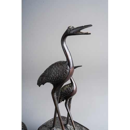 817 - A pair of early 20th Century Asian bronze figures of Cranes on stands and a Chinese bronze cast figu... 