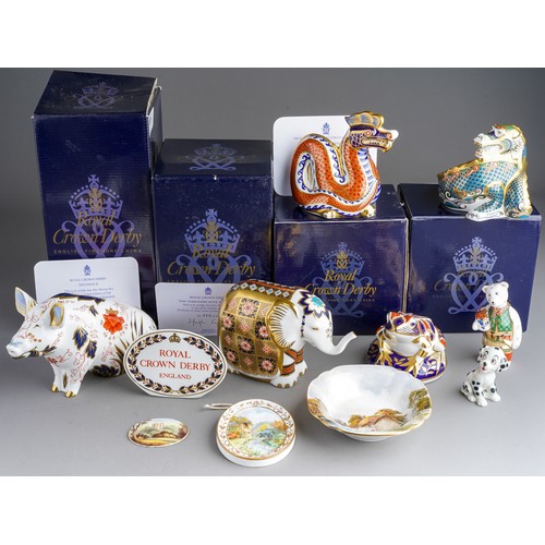 818 - A collection of Royal Crown Derby paperweight including: Happy Dragon, gold stopper with box and cer... 