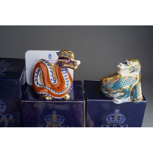 818 - A collection of Royal Crown Derby paperweight including: Happy Dragon, gold stopper with box and cer... 