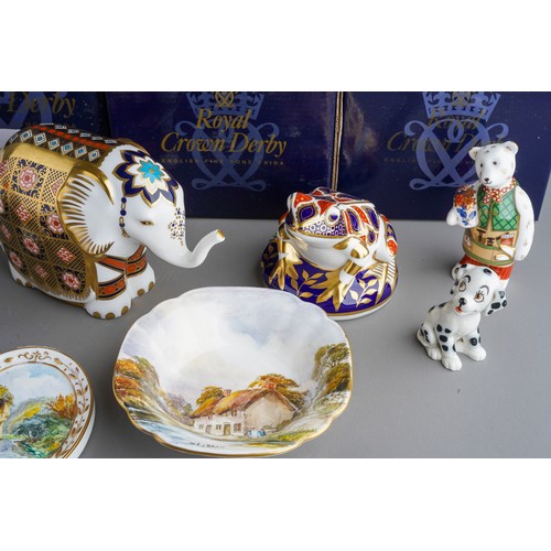 818 - A collection of Royal Crown Derby paperweight including: Happy Dragon, gold stopper with box and cer... 