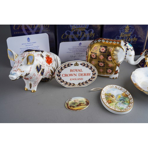 818 - A collection of Royal Crown Derby paperweight including: Happy Dragon, gold stopper with box and cer... 