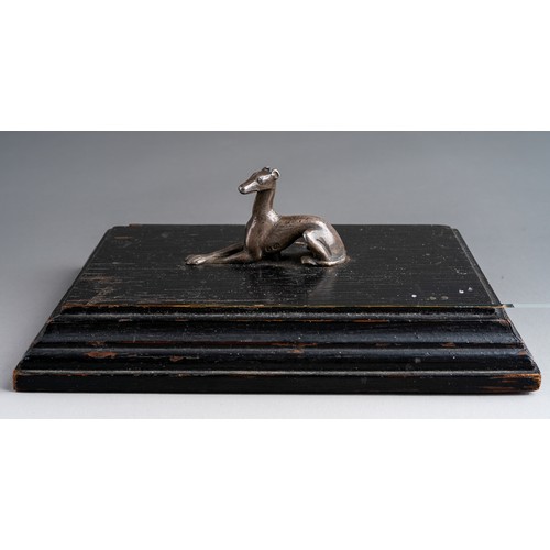 820 - Paperweight: a 19th Century silver model of a recumbent greyhound \ lurcher mounted on painted wood ... 