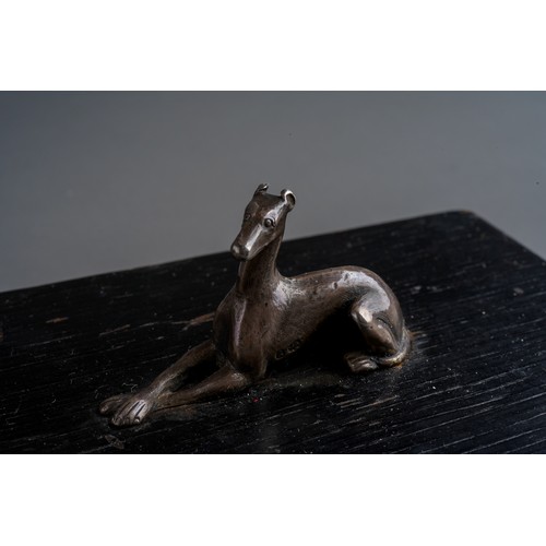 820 - Paperweight: a 19th Century silver model of a recumbent greyhound \ lurcher mounted on painted wood ... 