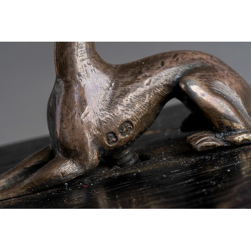 820 - Paperweight: a 19th Century silver model of a recumbent greyhound \ lurcher mounted on painted wood ... 