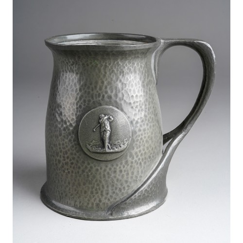 821 - A Tudric pewter planished presentation mug, central plaque with a golfer, stamped to base and number... 