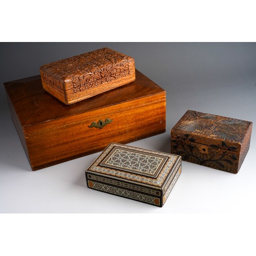 832 - Four wooden boxes to include a carved wood one, pokerwork , bone and various wood inlayed one and a ... 