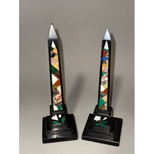 838 - A pair of Ashbourne obelisks inlaid with various coloured stones. Approx. 25 cm tall