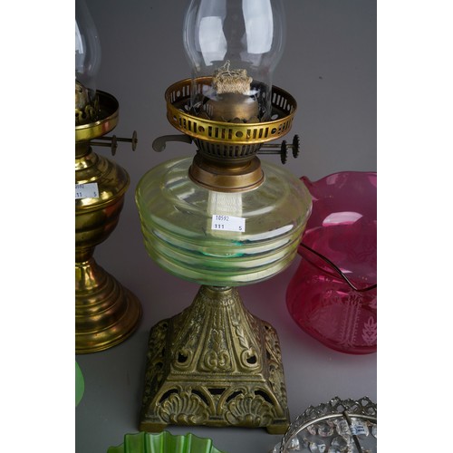 841 - Two brass base oil lamps together with 2 green glass shades and a crystal droplet shade