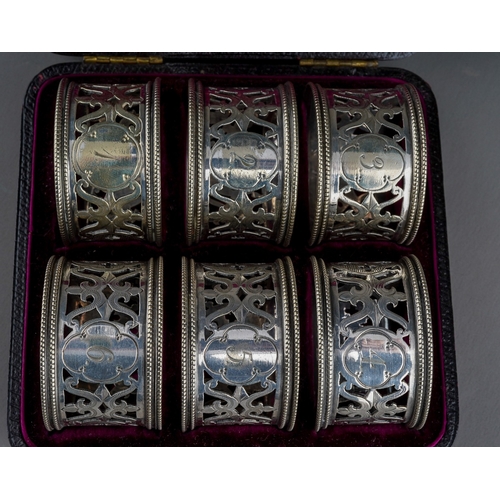 854 - A cased set of six late Victorian Elkington & Co silver plated napkin rings, of circular pierced for... 