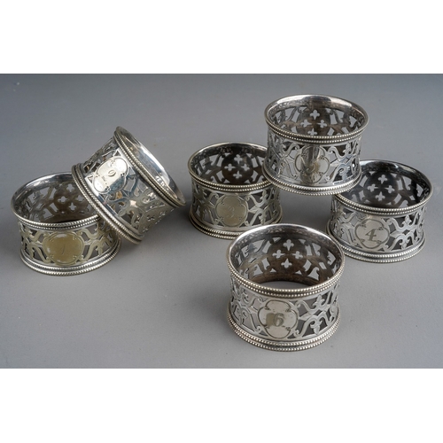 854 - A cased set of six late Victorian Elkington & Co silver plated napkin rings, of circular pierced for... 