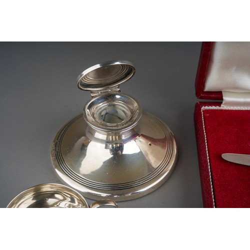 858 - A parcel of items of silver, comprising an early 20th century capstan inkwell, damaged clear glass s... 