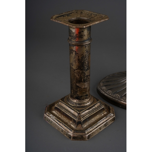 859 - A pair of George V silver dwarf candlesticks, square drip pans and stepped square loaded bases, lack... 