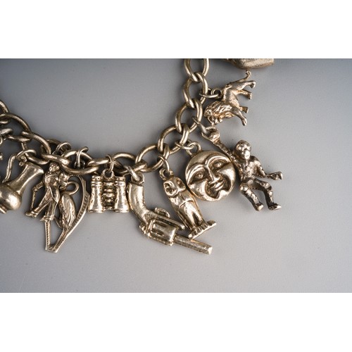 861 - Silver charm bracelet with various charms and heart shaped lock, gross weight approx 63g