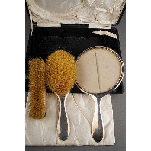 863 - A George V silver dressing table set, engine turned with monogram (mirror and two brushes,  hallmark... 