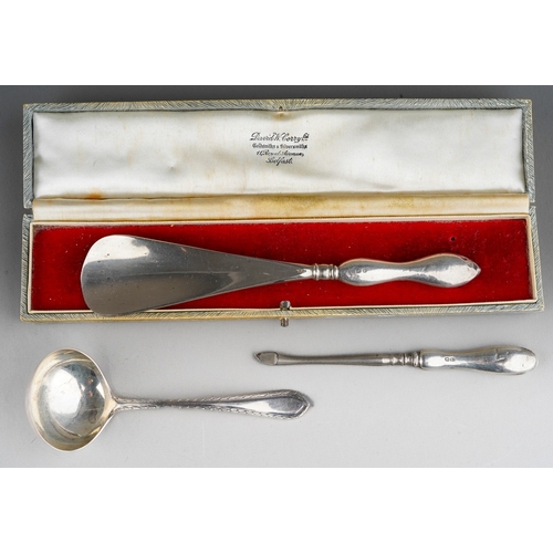 876 - Three pieces of silver, comprising a steel shoe horn with silver handle, a silver handled manicure t... 