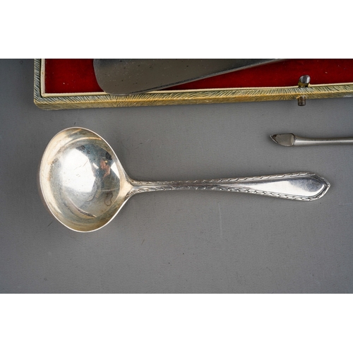 876 - Three pieces of silver, comprising a steel shoe horn with silver handle, a silver handled manicure t... 