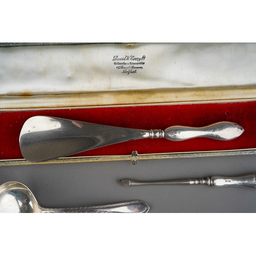 876 - Three pieces of silver, comprising a steel shoe horn with silver handle, a silver handled manicure t... 