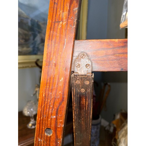 898 - An early 20th century stained pine picture easel, bears worn transfer mark for ESA, comes with two w... 