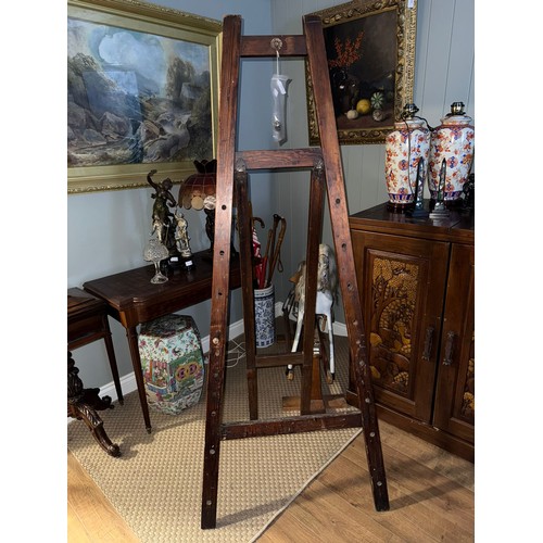 898 - An early 20th century stained pine picture easel, bears worn transfer mark for ESA, comes with two w... 