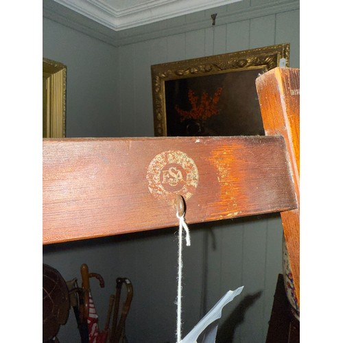 898 - An early 20th century stained pine picture easel, bears worn transfer mark for ESA, comes with two w... 