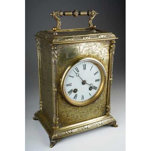 906 - A Victorian brass mantle clock white enamel dial with Roman numerals, with carrying handle, ornate b... 