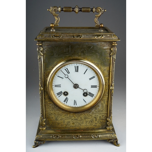 906 - A Victorian brass mantle clock white enamel dial with Roman numerals, with carrying handle, ornate b... 