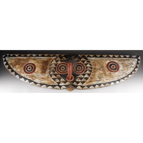 957 - Tribal interest: a carved African wooden butterfly mask in the form of outstretched wings, face shap... 