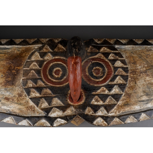 957 - Tribal interest: a carved African wooden butterfly mask in the form of outstretched wings, face shap... 