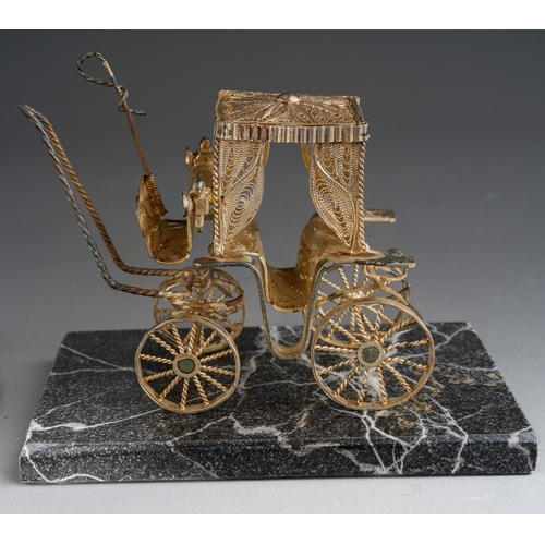 963 - A Continental white metal filigree model of a carriage on granite stand together with a heart shaped... 