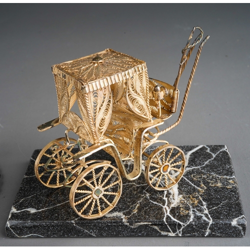 963 - A Continental white metal filigree model of a carriage on granite stand together with a heart shaped... 