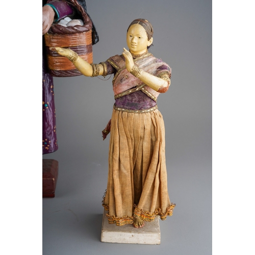 964 - A carved wooden figure of an Indian /Eastern fisherman carrying two fish on a removable pole, height... 