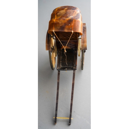 966 - A tortoiseshell and yellow metal mounted rickshaw, one wheel with damage,  height 10cm x length 14cm... 