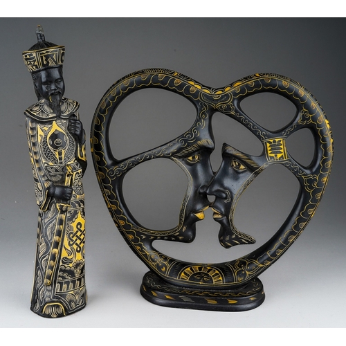 971 - An Asian heart shaped engraved ebony sculpture depicting a couple kissing and an similar carved and ... 