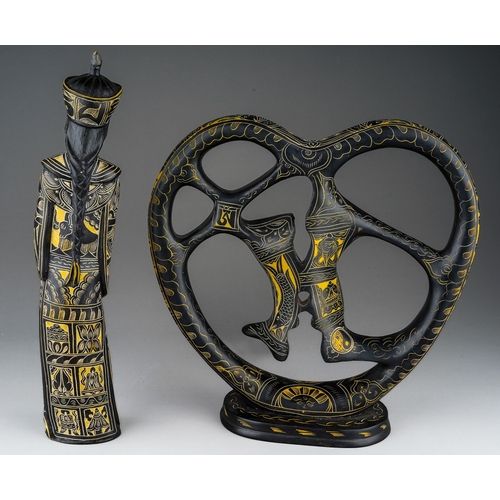 971 - An Asian heart shaped engraved ebony sculpture depicting a couple kissing and an similar carved and ... 