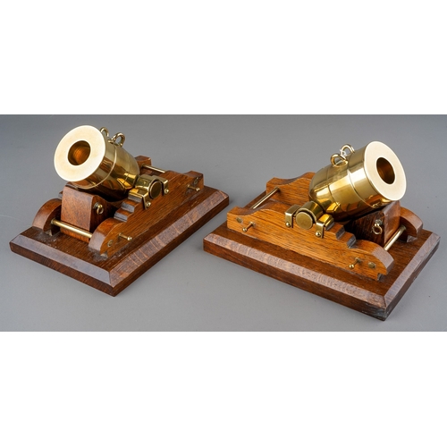 977 - A pair of 20th century brass and oak ornamental desk canons by Cannon Craft, stamped 3 J P to bases,... 