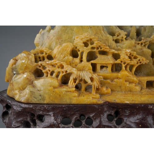 978 - A carved Chinese soapstone ornament of a mountainous landscape on a scrolled base, height 13cm x wid... 