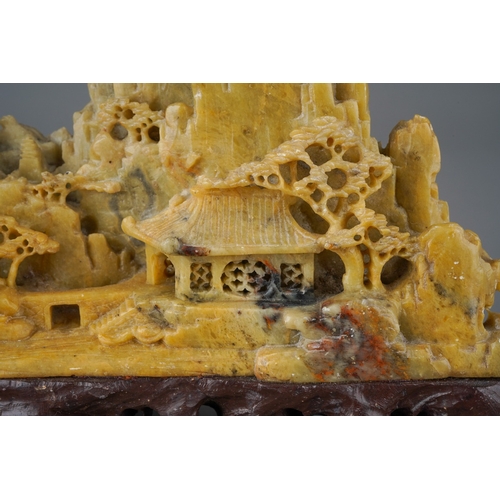 978 - A carved Chinese soapstone ornament of a mountainous landscape on a scrolled base, height 13cm x wid... 