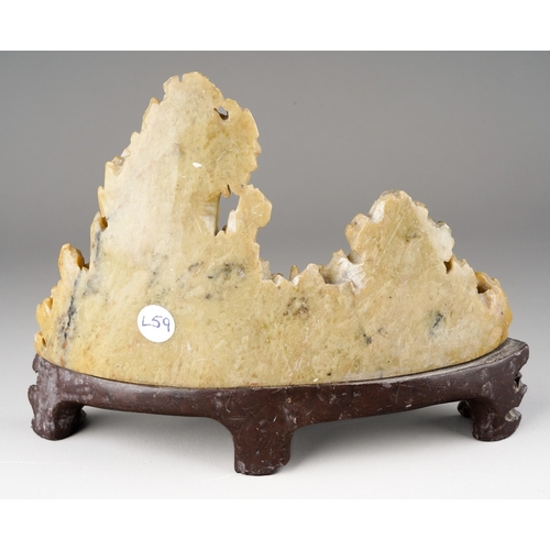 978 - A carved Chinese soapstone ornament of a mountainous landscape on a scrolled base, height 13cm x wid... 