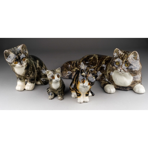 982 - A Winstanley figure of a reclining cat and three Winstanley seated kittens, length of cat 39cm x hei... 