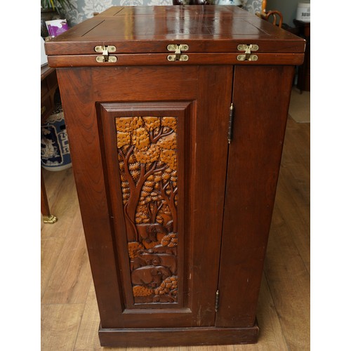 990 - A second half 20th century Chinese hardwood carved bar, the rectangular double hinged top opening ov... 