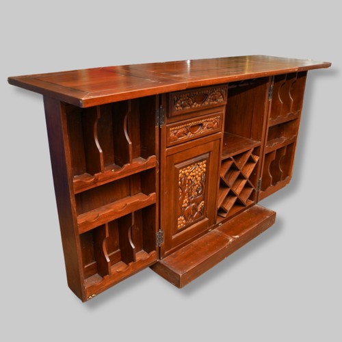 990 - A second half 20th century Chinese hardwood carved bar, the rectangular double hinged top opening ov... 