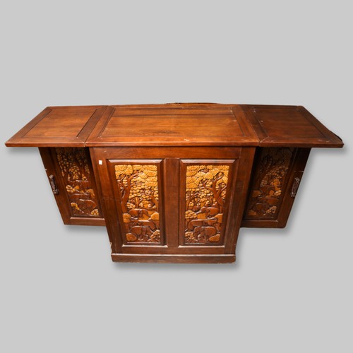 990 - A second half 20th century Chinese hardwood carved bar, the rectangular double hinged top opening ov... 