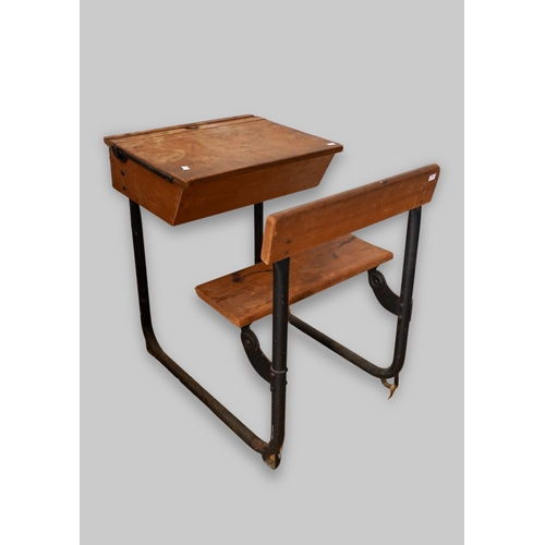 995 - A vintage child's school desk, black painted metal tubular frame with wooden back rest, folding seat... 