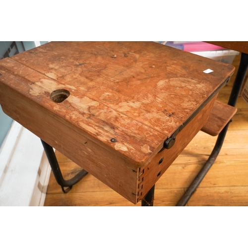 995 - A vintage child's school desk, black painted metal tubular frame with wooden back rest, folding seat... 